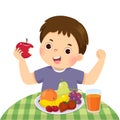 Cartoon of a little boy eating red apple and showing his strength