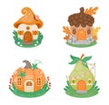 Cartoon little fantasy houses. Cute small gnome buildings in shape of mushroom, pumpkin, pear and acorn on green lawn Royalty Free Stock Photo