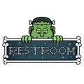 Cartoon Mascot Of Cute Frankenstein With Restroom Signboard.