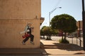 Cartoon mural of a Blue Collar Worker on side of Building in Empty Small Town in Oklahoma