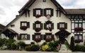 Cartoon picture of a traditional German house ornated with flowers.