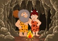 Cartoon prehistoric caveman couple with cave background