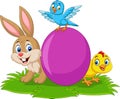 Cartoon rabbit with baby chick, bluebird and egg on the grass Royalty Free Stock Photo