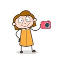 Cartoon Salesgirl Showing a Digital Camera for Sale