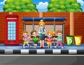 Cartoon of school children in the bus stop with a teacher Royalty Free Stock Photo