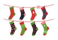 Cartoon socks. Children clothing elements with cute Christmas patterns drying on rope, Vector winter holidays flat set