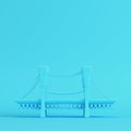 Cartoon styled bridge on bright blue background in pastel colors. Minimalism concept