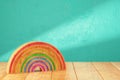 Cartoon styled rainbow on wooden table