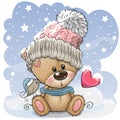 Cartoon Teddy bear in a knitted cap sits on a snow