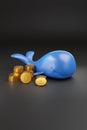 Cartoon whale with bitcoin coins on black background. 3d illustration