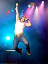 Cartoonize Young man singing and jumping on stage at concert Royalty Free Stock Photo