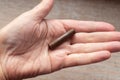 A cartridge case from an old Nagan revolver cartridge in the palm of your hand. War finds of the early 20th century Royalty Free Stock Photo