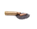 Cartridge case and a pile of gunpowder Royalty Free Stock Photo