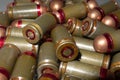 Cartridges bulk close up images. Bullets in shells for gun are piled randomly. Weapon armory concept