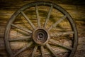 Cartwheel at the old sraw wall of a house Royalty Free Stock Photo