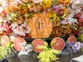 Carved cantaloupe surrounded by gorgeous colorful flowers and grapefruits in Mexico City