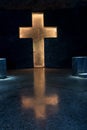 Carved Catholic cross illuminated with yellow light on a wall of the Salt Cathedral in Colombia. Royalty Free Stock Photo