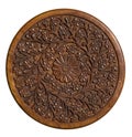 Carved circular wood panel with floral design