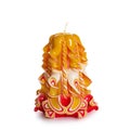 Carved colored candle on white background