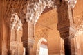 Carved columns with Islamic calligraphy and patterns, inside the 14th century palace of Alhambra