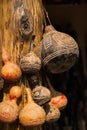 Carved decorative African gourds hanging on post