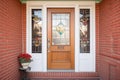 carved door surround with leaded glass on red brick