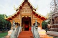 Carved entrance with statues at ancient Buddhist temple structure Royalty Free Stock Photo