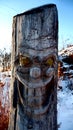 Carved face on a tree trunk disturbing smile Royalty Free Stock Photo