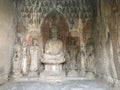 Carved figures with Sakyamuni statue in Grotto Royalty Free Stock Photo