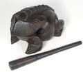 Carved frog with stick