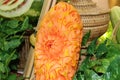 Carved fruit of ripe papaya in orange color to flower form.