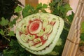 Carved fruit of watermelon to flower form and green leaves.