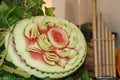 Carved fruit of watermelon to flower form and green leaves.