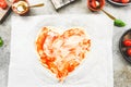 Carved from heart pizza dough on baking paper