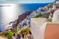 Carved houses and tourists waitng for the sun Oia Santorini