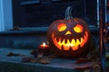 carved and illuminated jack-o-lantern on a doorstep Royalty Free Stock Photo