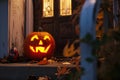 carved and illuminated jack-o-lantern on a doorstep Royalty Free Stock Photo