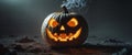 A carved illuminated pumpkin sitting on a dark ground Royalty Free Stock Photo