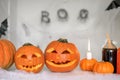 Carved Jack-o\'-lantern pumpkins with a magic potion in bottles stand on a table Royalty Free Stock Photo