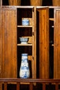 Carved mahogany cabinet and porcelain vase in Lingnan style, Guangdong, China Royalty Free Stock Photo