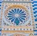 Carved marble facade of Doumo of Monza and large lace rose window, Italy