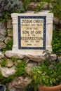 Stone Monument with Bible Verse in Tomb Garden Royalty Free Stock Photo