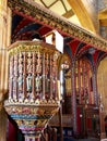 Carved and painted wooden pulpit and rood screen in medieval English church, UK