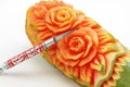 Carved papaya fruit and knife