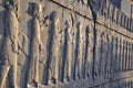 Carved Persians on the stone wall in Persepolis