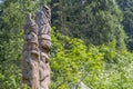 Carved pillars in a forest.