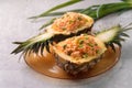 Carved pineapple stuffed with fresh pineapple tomato sauced seafood fried rice Royalty Free Stock Photo