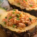 Carved pineapple stuffed with fresh pineapple tomato sauced seafood fried rice Royalty Free Stock Photo