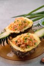 Carved pineapple stuffed with fresh pineapple tomato sauced seafood fried rice Royalty Free Stock Photo