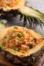 Carved pineapple stuffed with fresh pineapple tomato sauced seafood fried rice Royalty Free Stock Photo